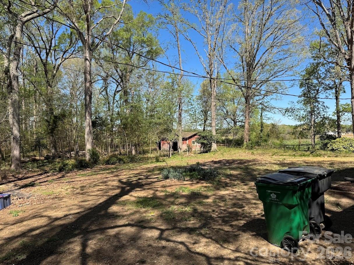 4424 Back Creek Church Road Charlotte, NC 28213 - Photo 15 of 15 a backyard of a house with table and chairs