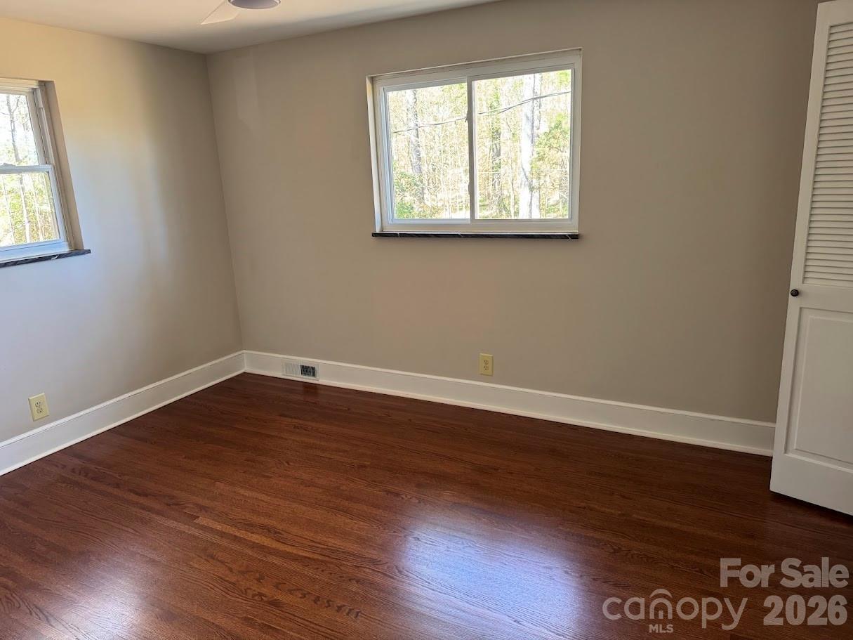 4424 Back Creek Church Road Charlotte, NC 28213 - Photo 9 of 15 an empty room with wooden floor and windows