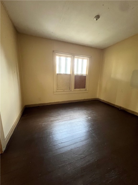 602 West Rice Street Falfurrias, TX 78355 - Photo 11 of 15 an empty room with wooden floor and windows
