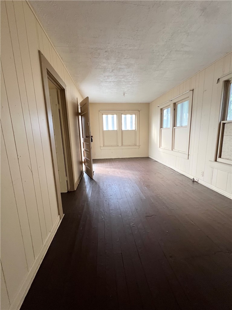 602 West Rice Street Falfurrias, TX 78355 - Photo 12 of 15 an empty room with wooden floor and windows