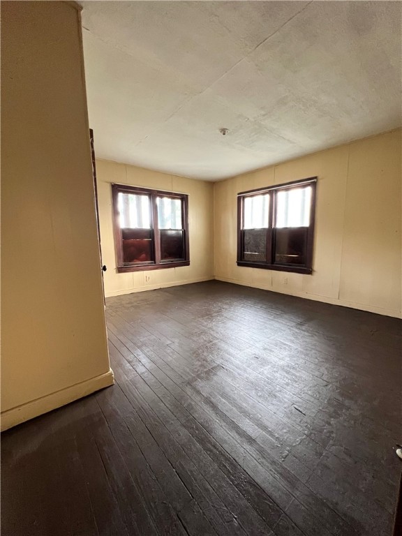 602 West Rice Street Falfurrias, TX 78355 - Photo 4 of 15 an empty room with wooden floor and windows