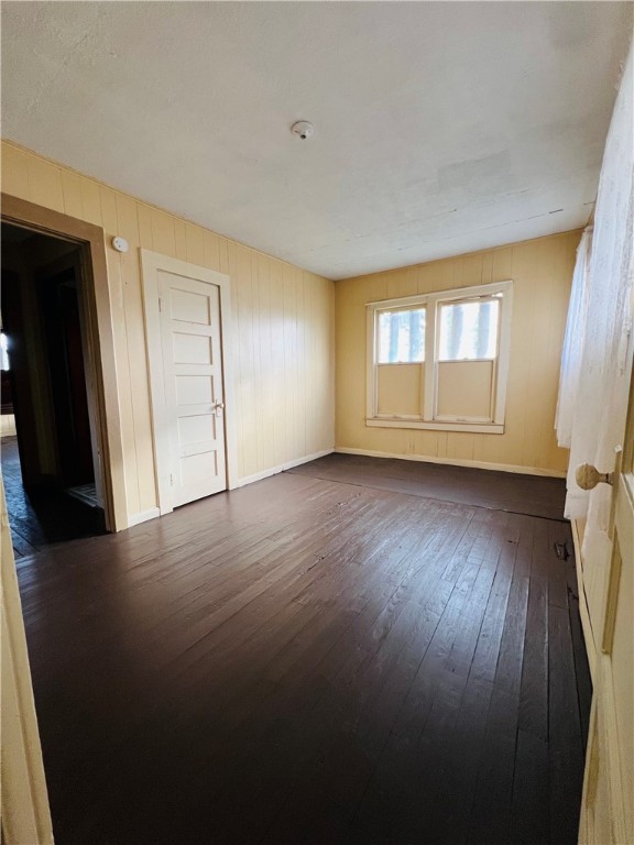 602 West Rice Street Falfurrias, TX 78355 - Photo 5 of 15 an empty room with wooden floor and windows