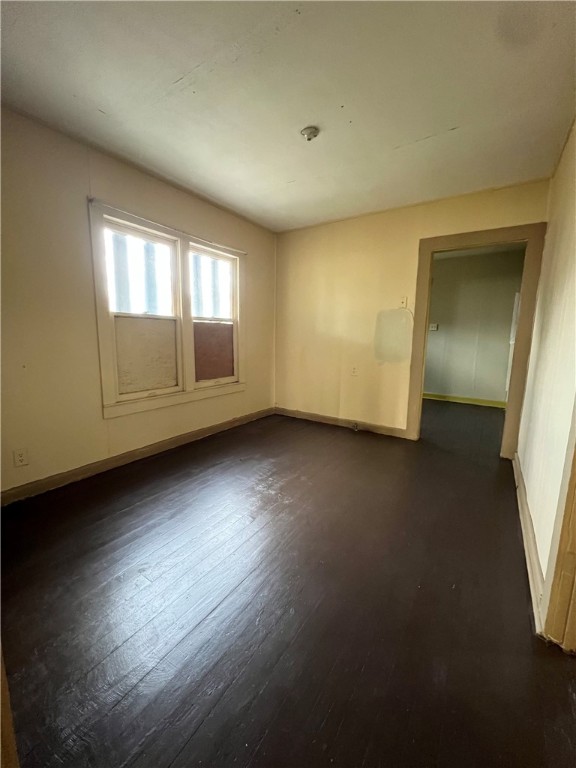 602 West Rice Street Falfurrias, TX 78355 - Photo 6 of 15 an empty room with wooden floor and windows