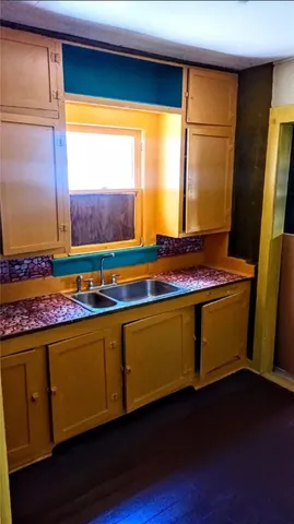 a view of a room with wooden floor and window