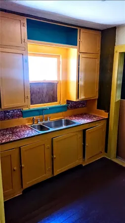 a room with wooden floor and window