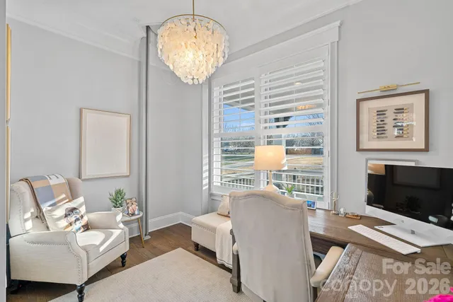 a living room with furniture a flat screen tv and a large window