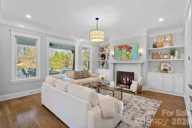 a living room with furniture fireplace and window