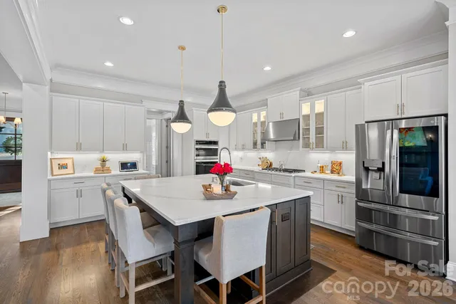 a kitchen that has a lot of cabinets a sink and appliances in it