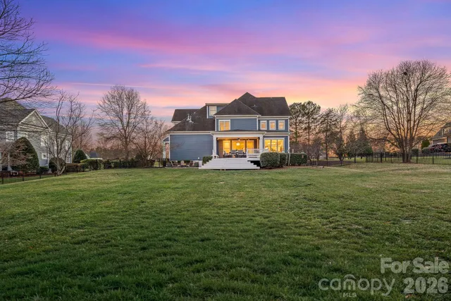 a front view of a house with a big yard