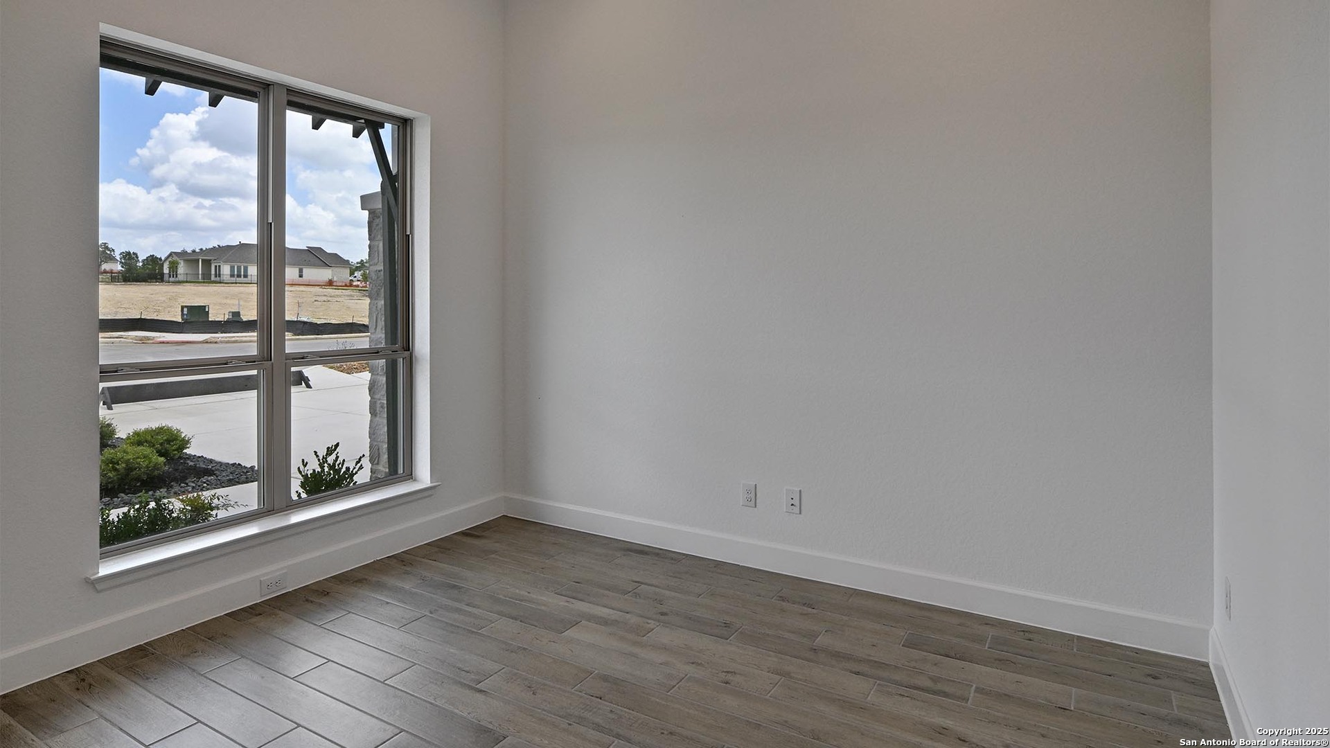 213 Fandango Boerne, TX 78006 - Photo 25 of 35 an empty room with wooden floor and a window
