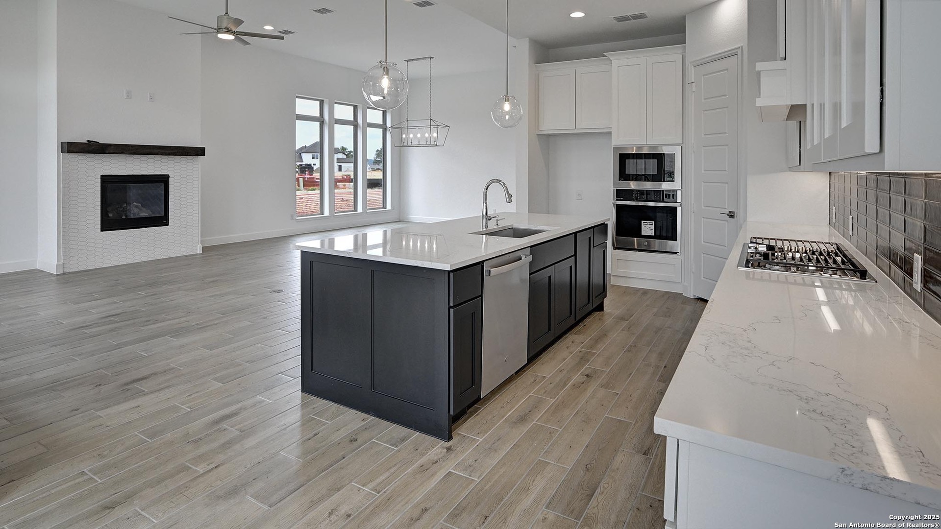 213 Fandango Boerne, TX 78006 - Photo 9 of 35 a large kitchen with stainless steel appliances granite countertop a stove a sink dishwasher and a oven with wooden floor