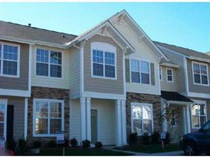 827 Gentlewinds Court, Unit 827 Fort Mill, SC 29708 - Photo 1 of 1 a view of a brick house with many windows