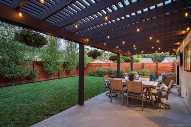 a view of a porch with chairs and backyard