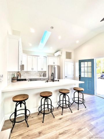 a kitchen with a table and chairs in it