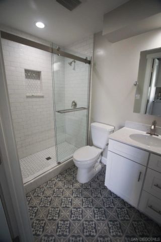 a bathroom with a toilet a sink and shower