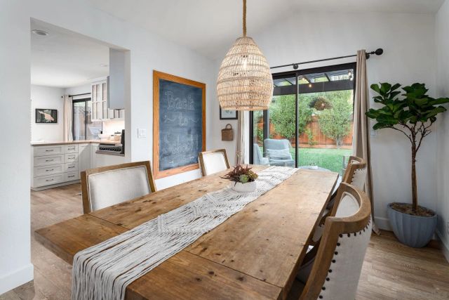 a living room with kitchen island furniture and a chandelier