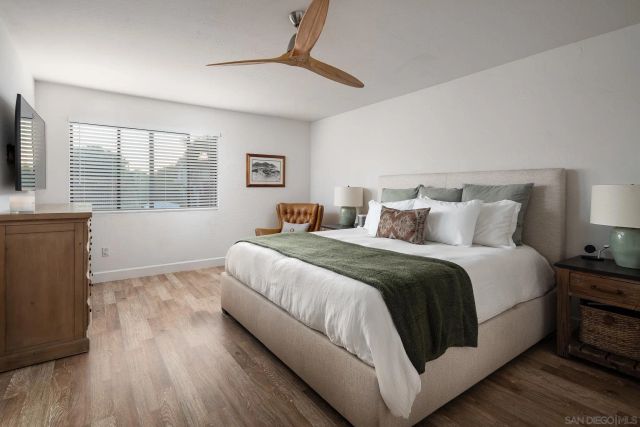 a bedroom with a bed and a large window