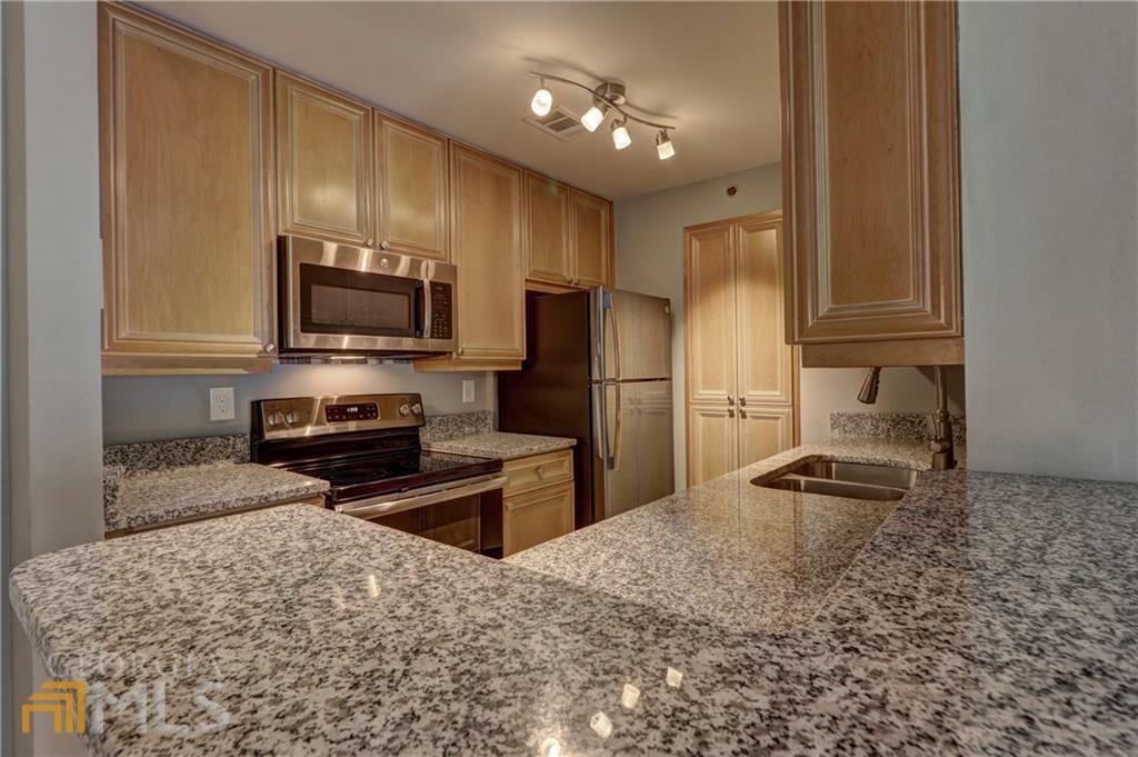 3203 Lenox Road Northeast, Unit 32 Atlanta, GA 30324 - Photo 1 of 1 a kitchen with granite countertop a refrigerator stove and sink