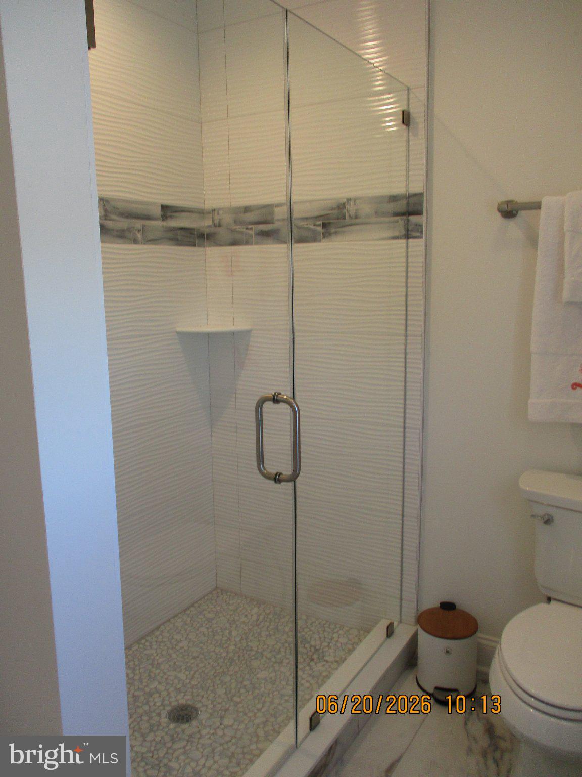 24 West 53rd Street Long Beach Township, NJ 08008 - Photo 74 of 75 Sleek glass shower with modern tiles.