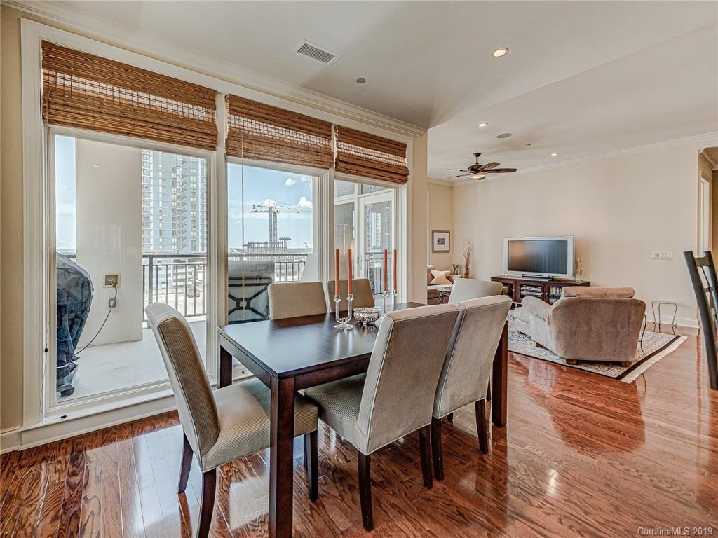230 South Tryon Street, Unit 710 Charlotte, NC 28202 - Photo 16 of 48 a view of a dining room with furniture window and wooden floor