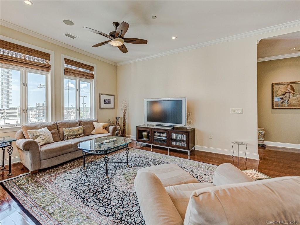 230 South Tryon Street, Unit 710 Charlotte, NC 28202 - Photo 18 of 48 a living room with furniture and a flat screen tv