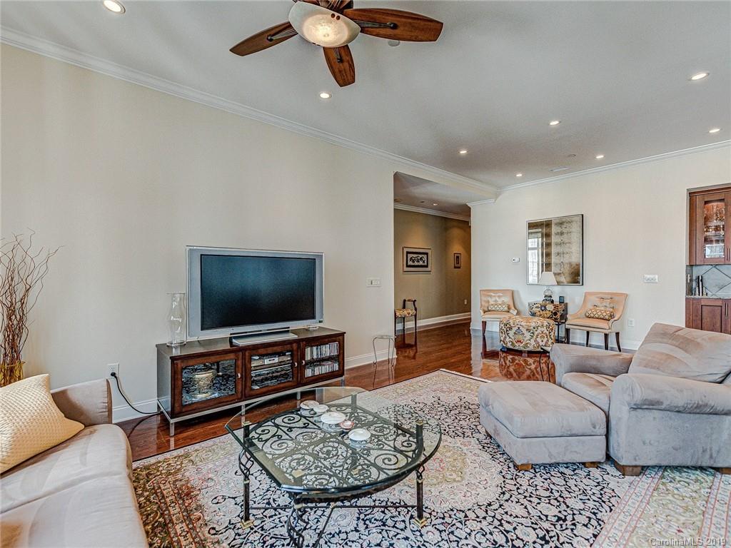 230 South Tryon Street, Unit 710 Charlotte, NC 28202 - Photo 19 of 48 a living room with furniture and a flat screen tv