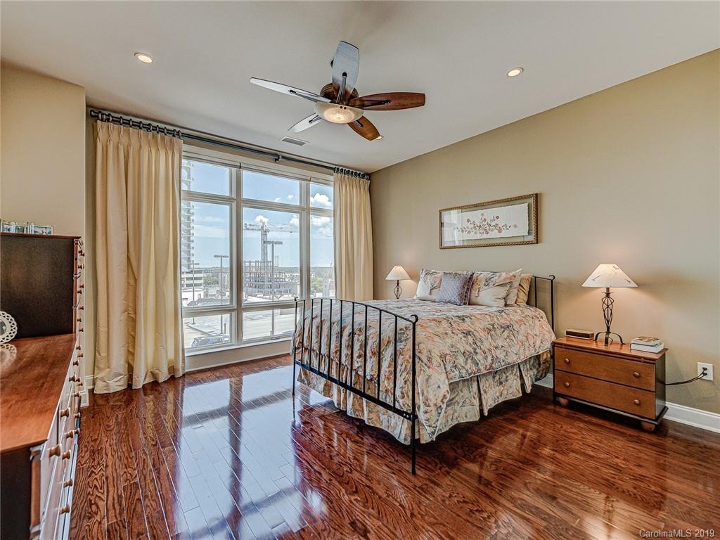 230 South Tryon Street, Unit 710 Charlotte, NC 28202 - Photo 20 of 48 a bedroom with a bed and a flat screen tv