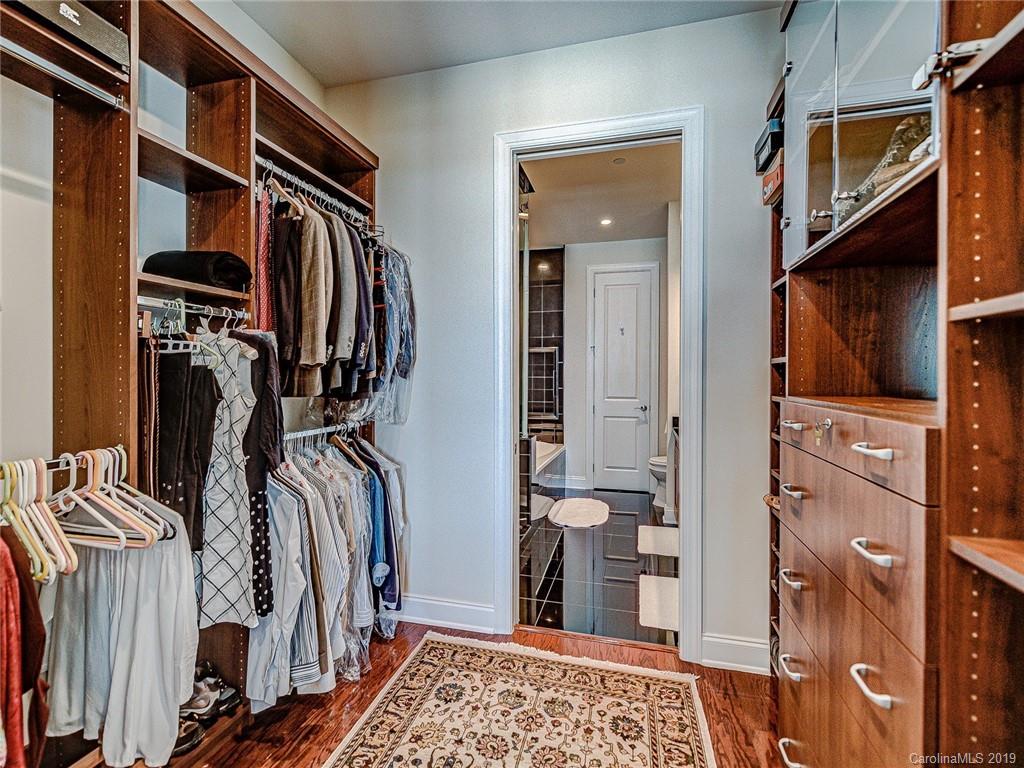230 South Tryon Street, Unit 710 Charlotte, NC 28202 - Photo 22 of 48 a view of walk in closet with clothes and shoes