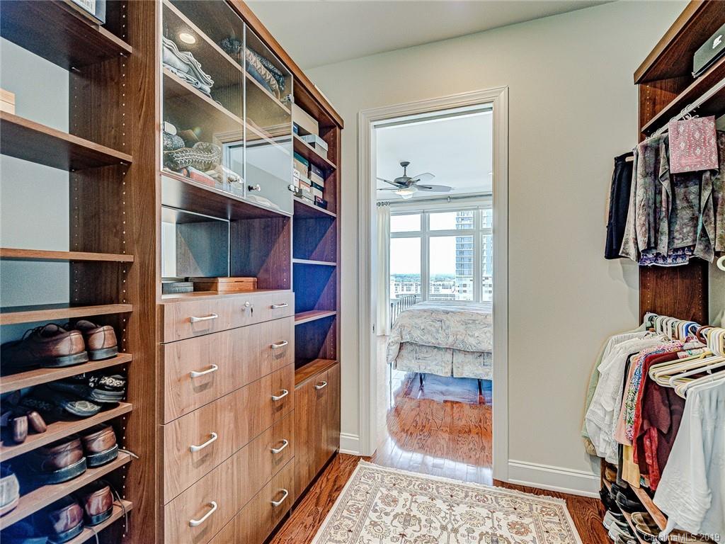 230 South Tryon Street, Unit 710 Charlotte, NC 28202 - Photo 26 of 48 a view of walk in closet with clothes and shoes
