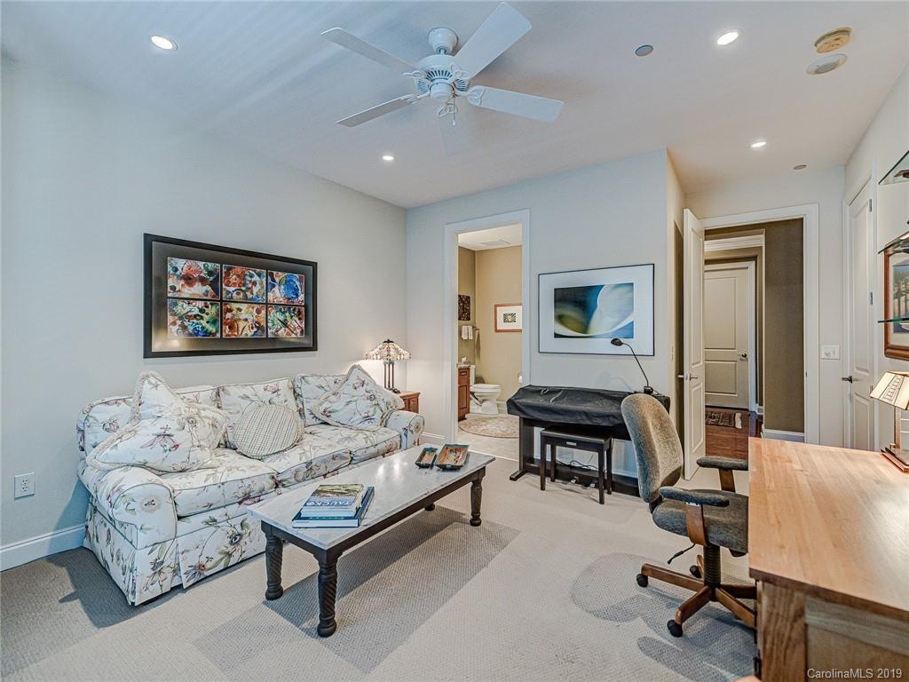 230 South Tryon Street, Unit 710 Charlotte, NC 28202 - Photo 30 of 48 a living room with furniture a rug and a piano