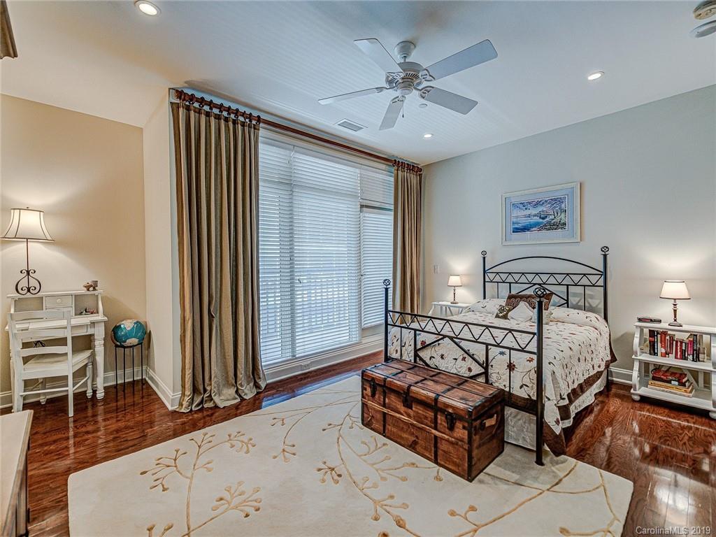 230 South Tryon Street, Unit 710 Charlotte, NC 28202 - Photo 31 of 48 a spacious bedroom with a bed a couch and dresser