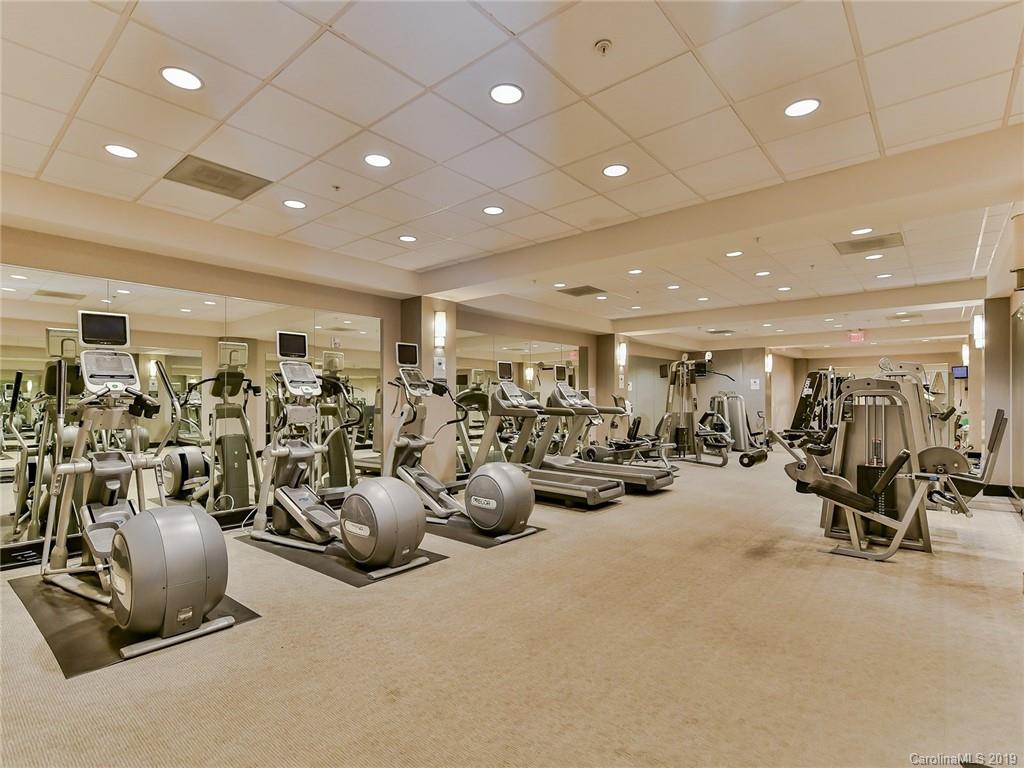 230 South Tryon Street, Unit 710 Charlotte, NC 28202 - Photo 37 of 48 a view of a room with gym equipment and large mirror