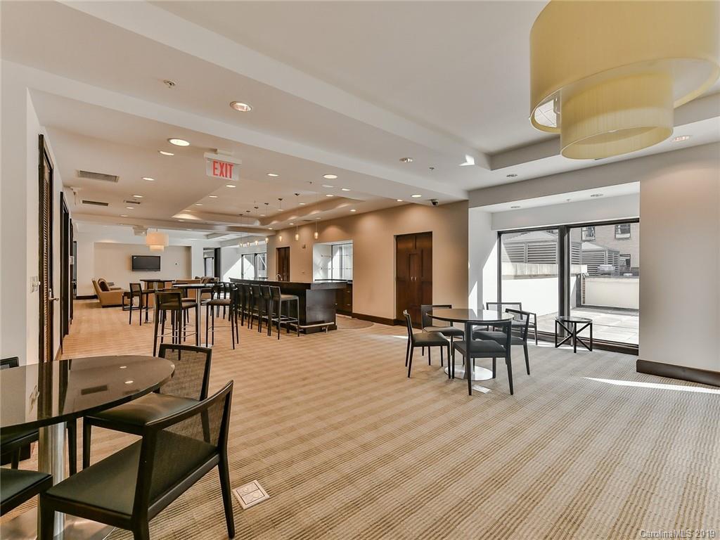 230 South Tryon Street, Unit 710 Charlotte, NC 28202 - Photo 38 of 48 a dining room with furniture and wooden floor