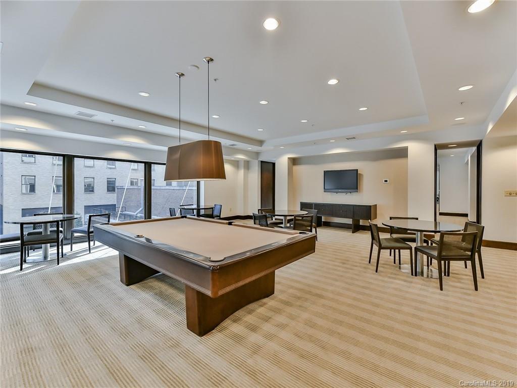 230 South Tryon Street, Unit 710 Charlotte, NC 28202 - Photo 40 of 48 a large room with table and chairs
