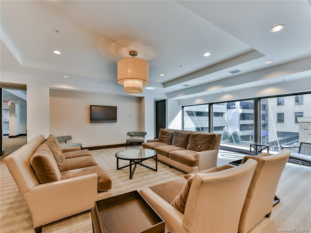 230 South Tryon Street, Unit 710 Charlotte, NC 28202 - Photo 41 of 48 a living room with furniture and a large window