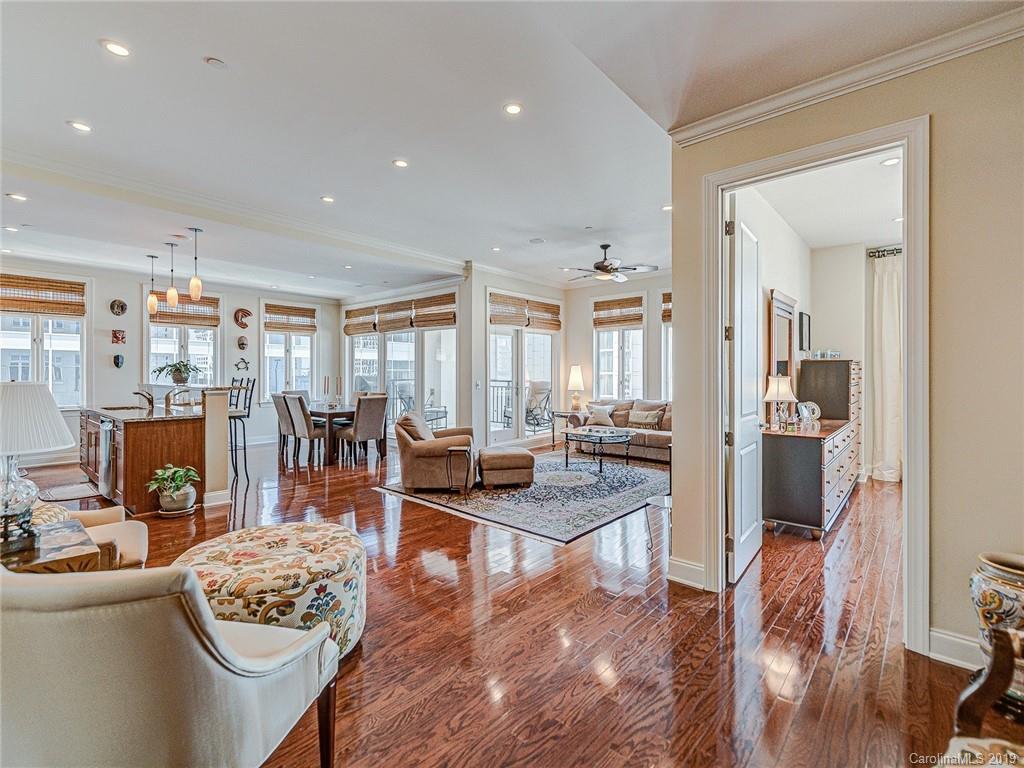 230 South Tryon Street, Unit 710 Charlotte, NC 28202 - Photo 6 of 48 a living room with furniture and wooden floor