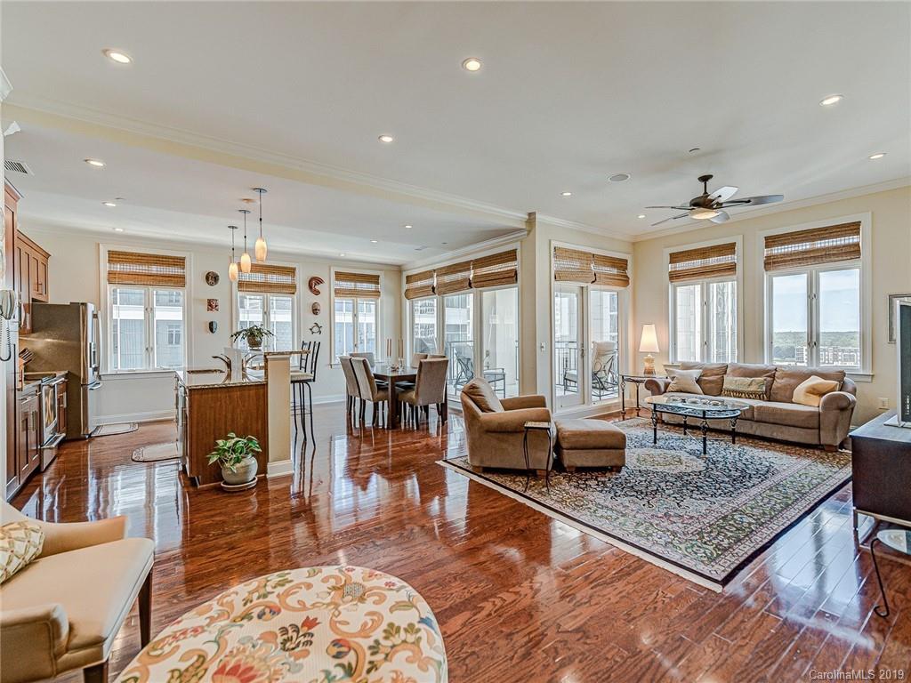 230 South Tryon Street, Unit 710 Charlotte, NC 28202 - Photo 7 of 48 a living room with furniture and a fireplace