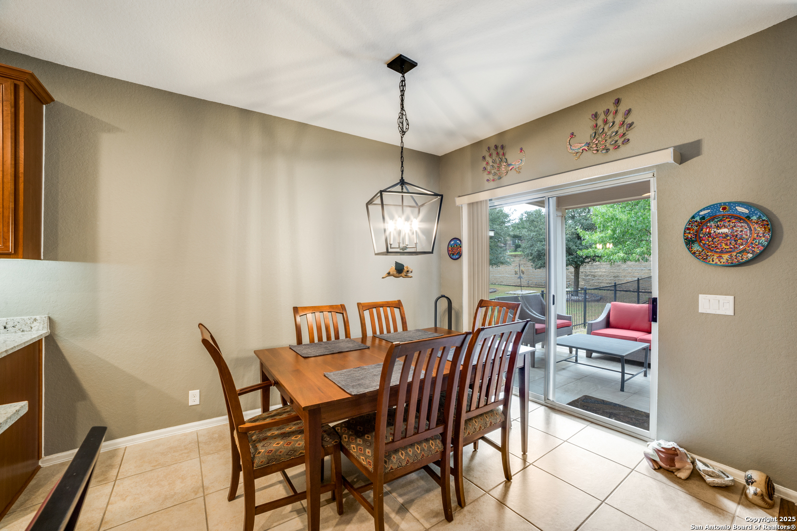 12434 Modena Bay San Antonio, TX 78253 - Photo 12 of 25 a view of a dining room with furniture large windows and wooden floor