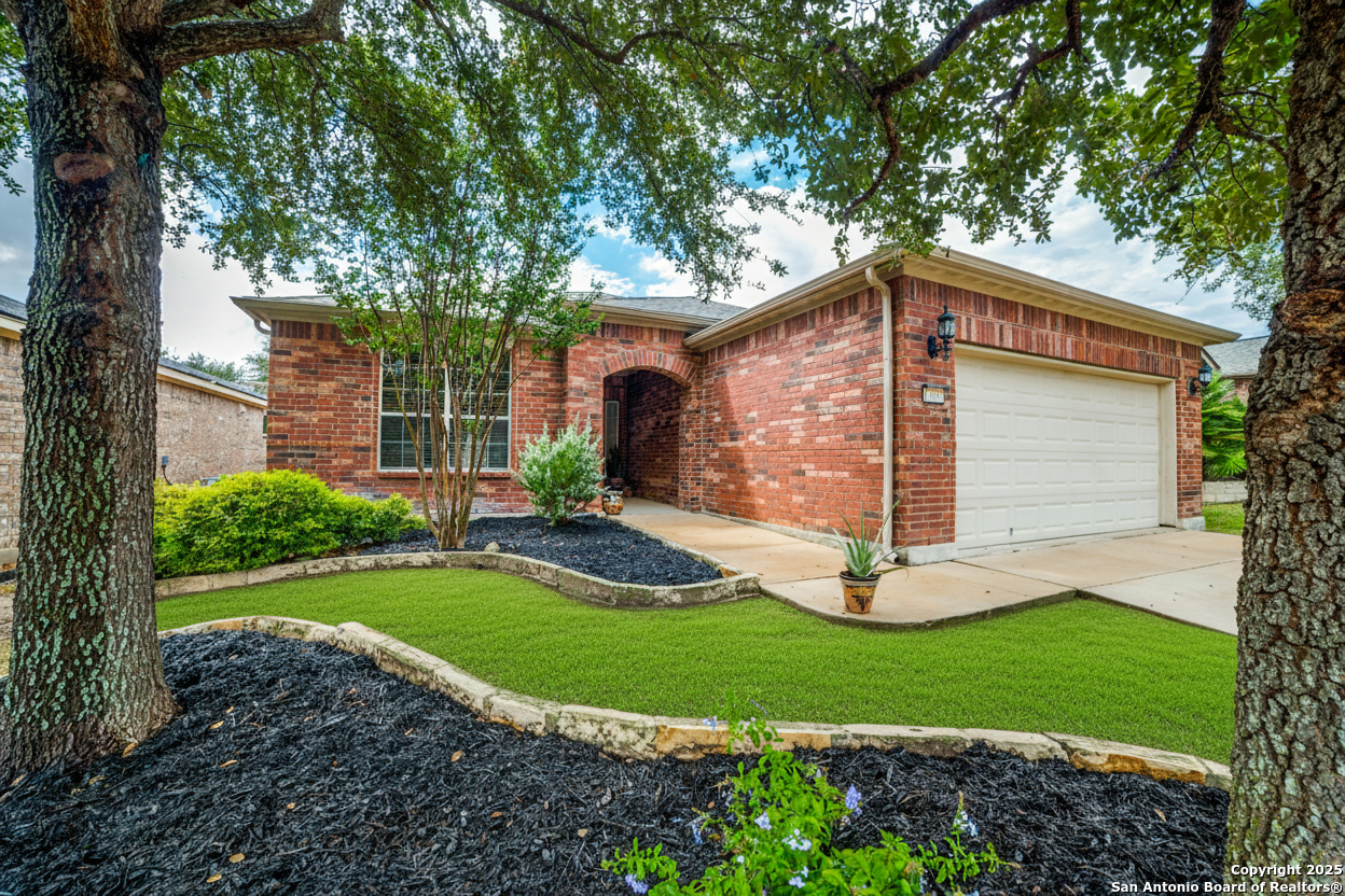 12434 Modena Bay San Antonio, TX 78253 - Photo 2 of 25 a front view of a house with a yard and garage