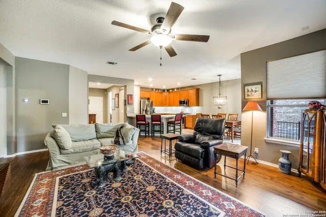 a living room with furniture ceiling fan and a rug
