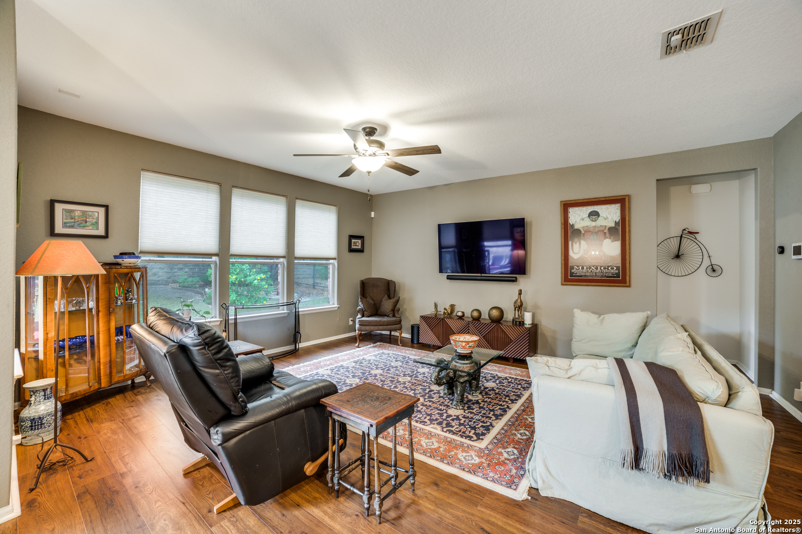 12434 Modena Bay San Antonio, TX 78253 - Photo 6 of 25 a living room with furniture a flat screen tv and a large window