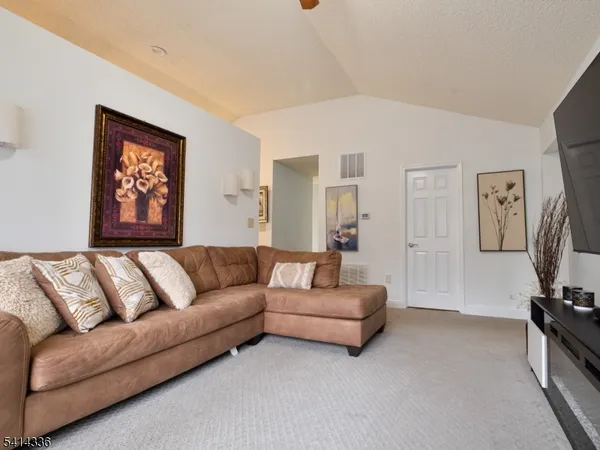 a living room with furniture and a chandelier