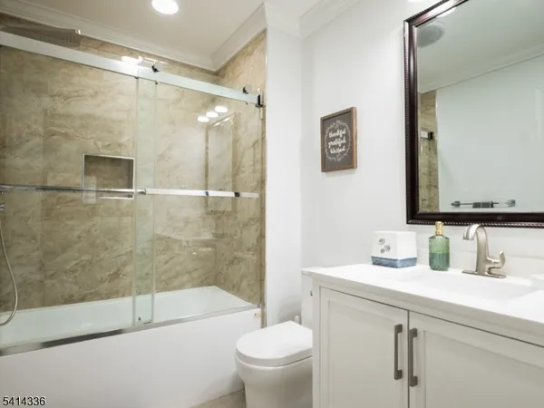 a bathroom with a shower a toilet and a sink