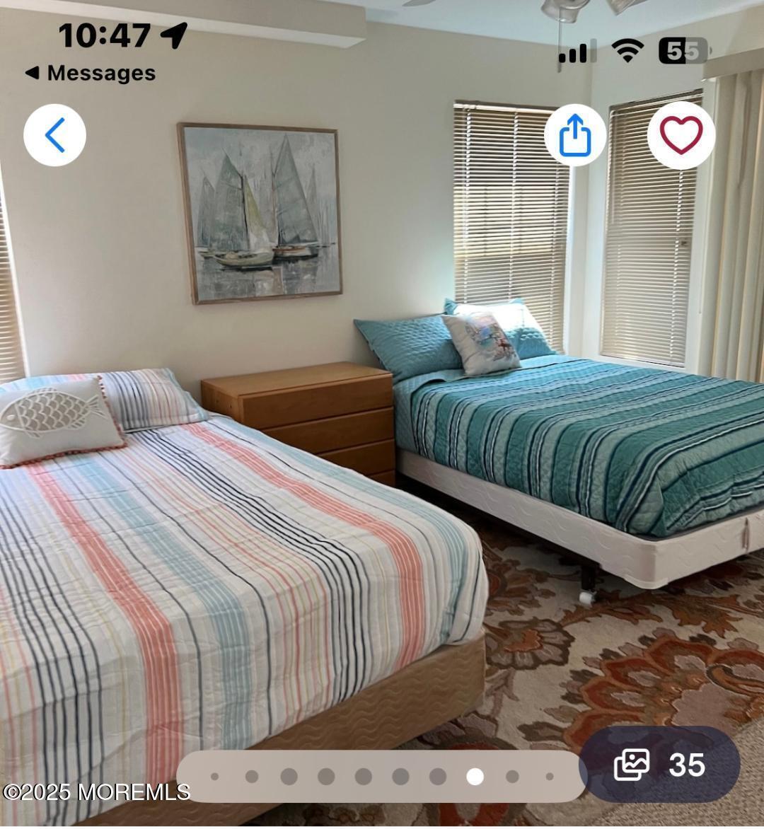 1301 Ocean Boulevard, Unit 1 Seaside Heights, NJ 08751 - Photo 11 of 13 a bedroom with a bed and painting on the wall