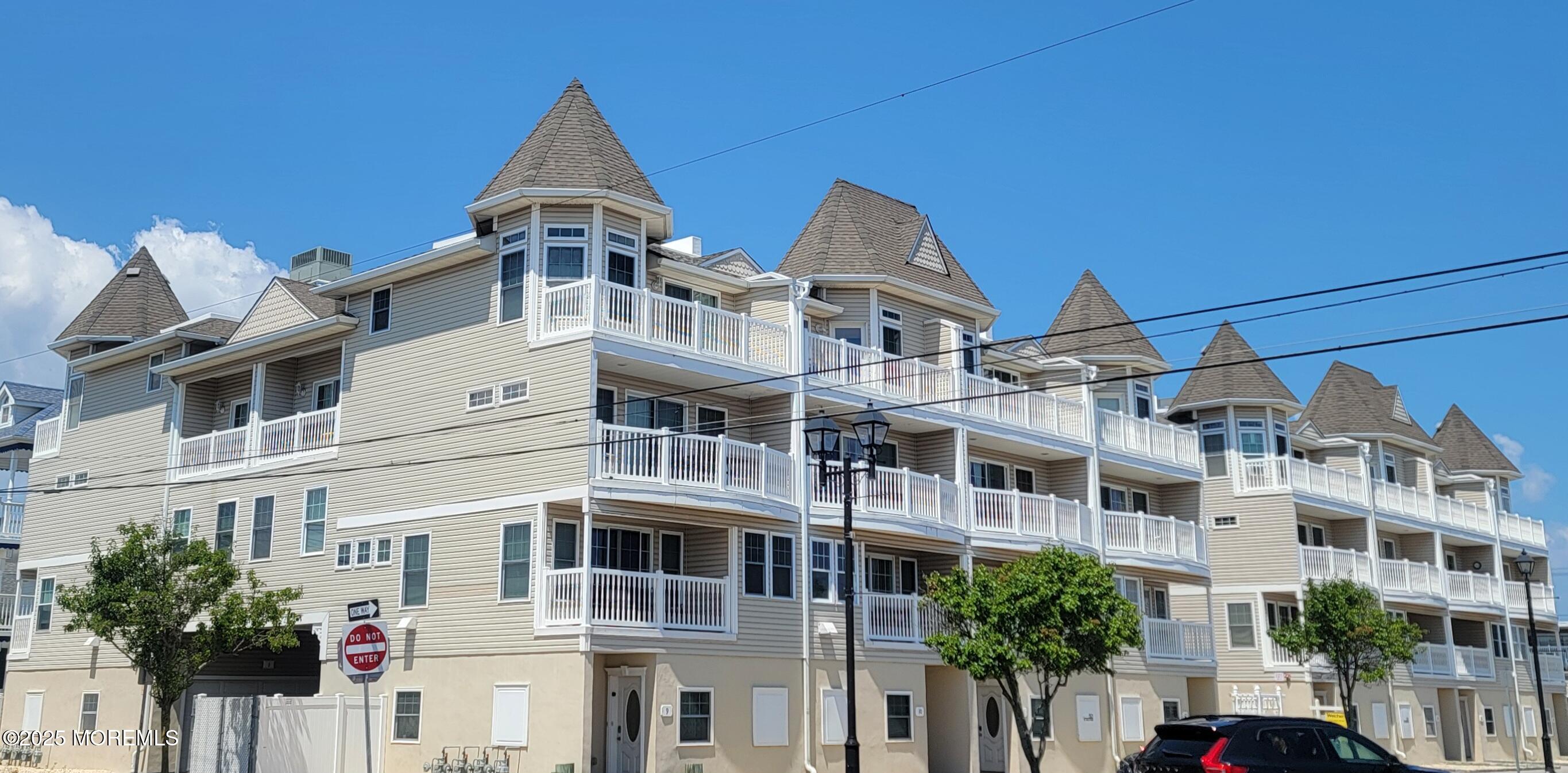 1301 Ocean Boulevard, Unit 1 Seaside Heights, NJ 08751 - Photo 13 of 13 a view of a white building among the street with palm trees