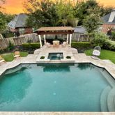 a view of a house with pool backyard and furniture
