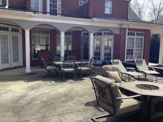 2125 Keith Hills Road Lillington, NC 27546 - Photo 60 of 66 a view of a patio with couches table and chairs and potted plants