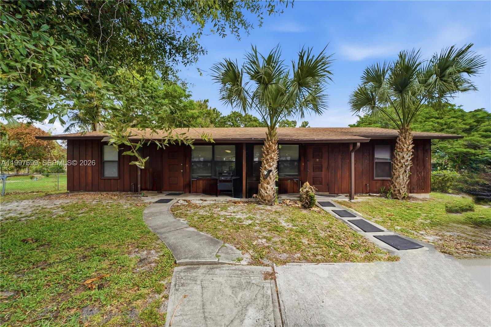 1910 South 34th Street Fort Pierce, FL 34947 - Photo 1 of 24 a front view of a house with garden