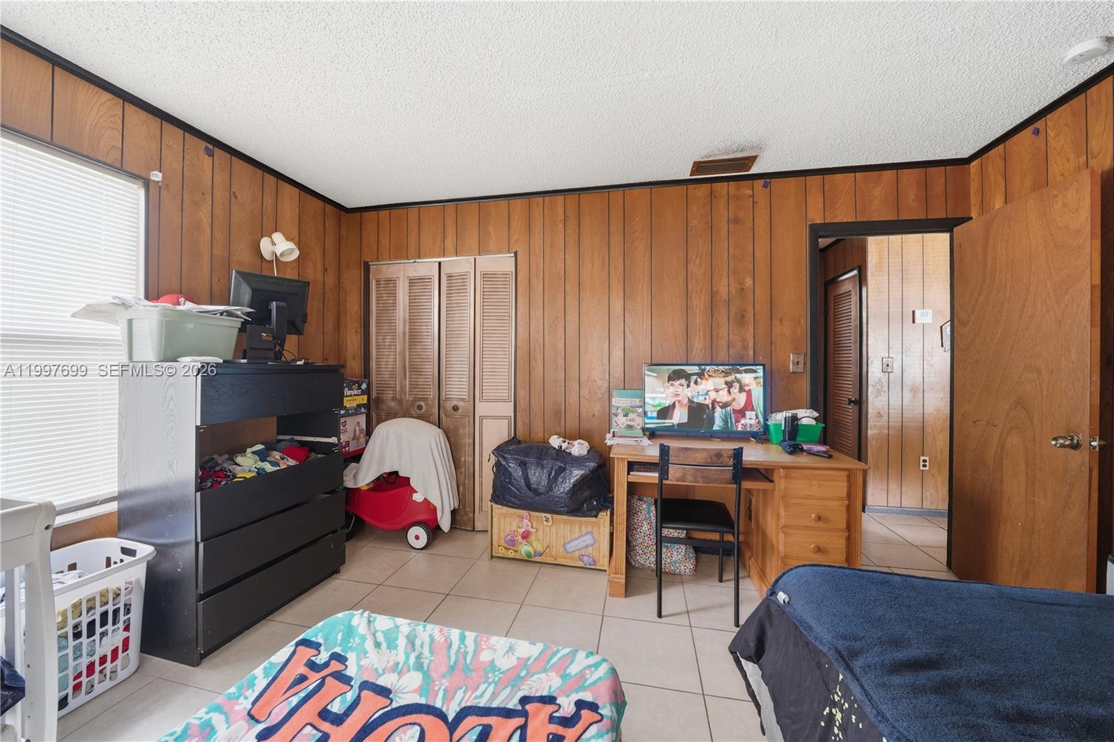 1910 South 34th Street Fort Pierce, FL 34947 - Photo 11 of 24 a bedroom with furniture and a chair
