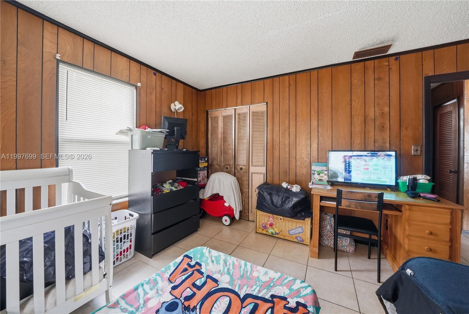 1910 South 34th Street Fort Pierce, FL 34947 - Photo 13 of 24 a bedroom with furniture and a window